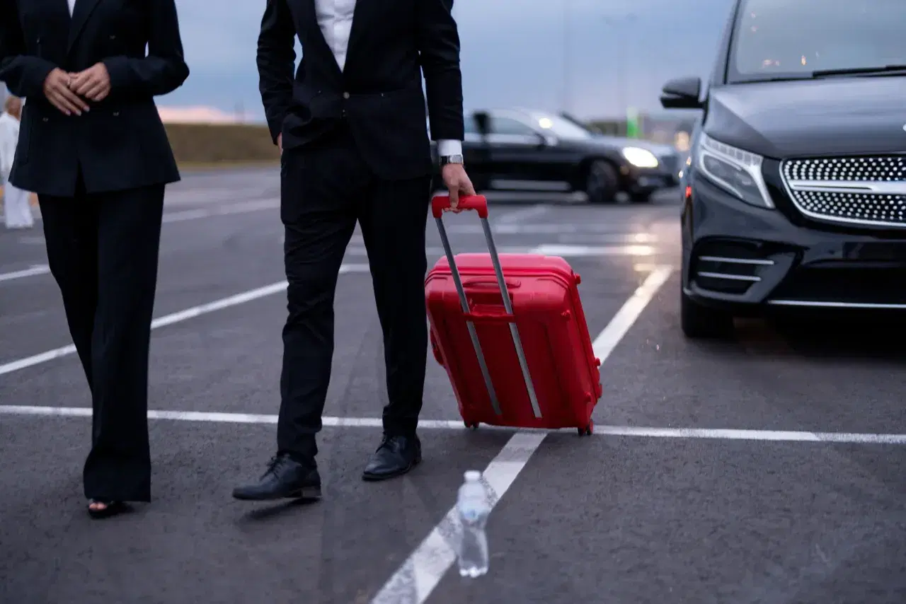 Passengers with luggage at an airport for chauffeur transfer